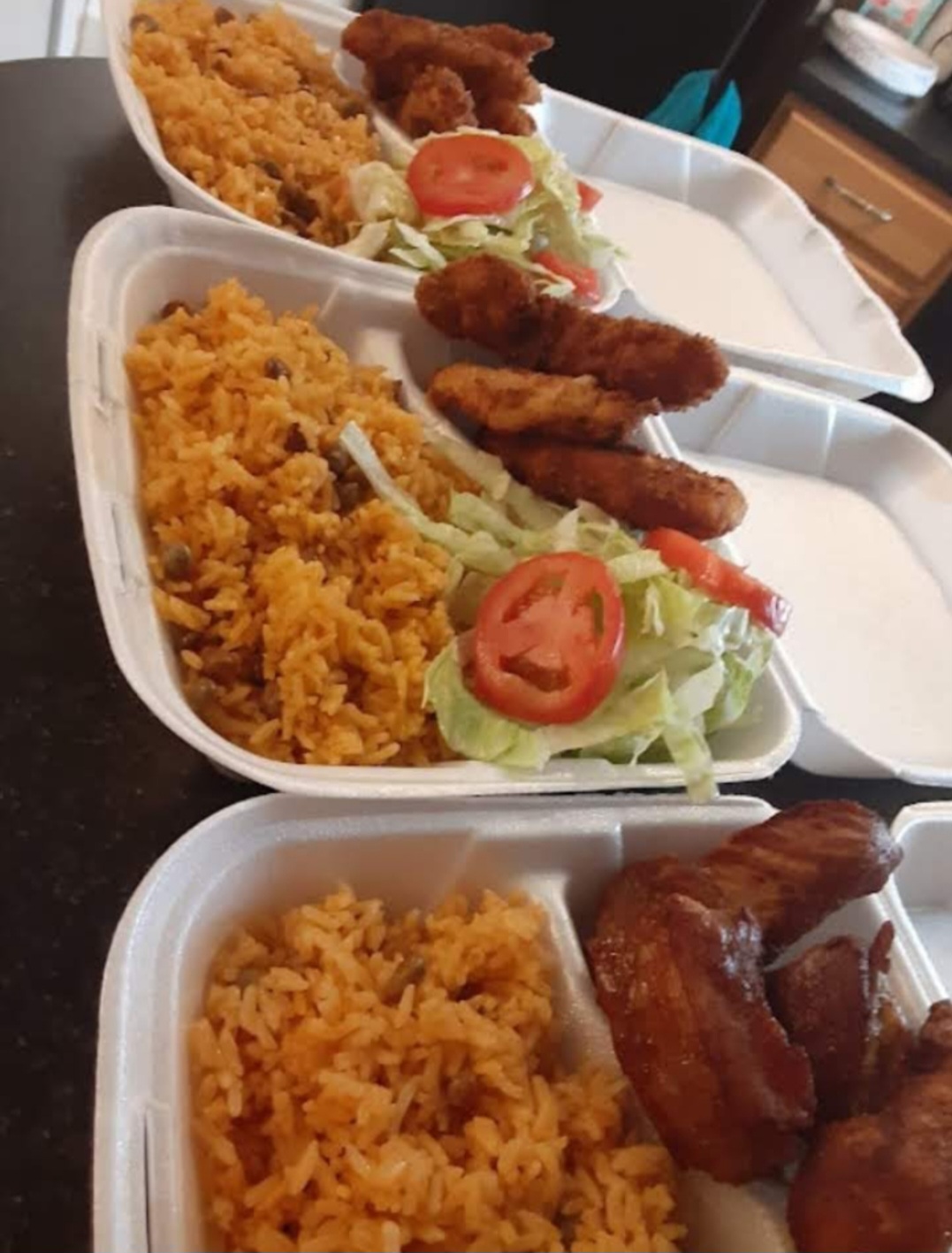 Family dinner table showing golden roasted pernil with yellow rice and plantains