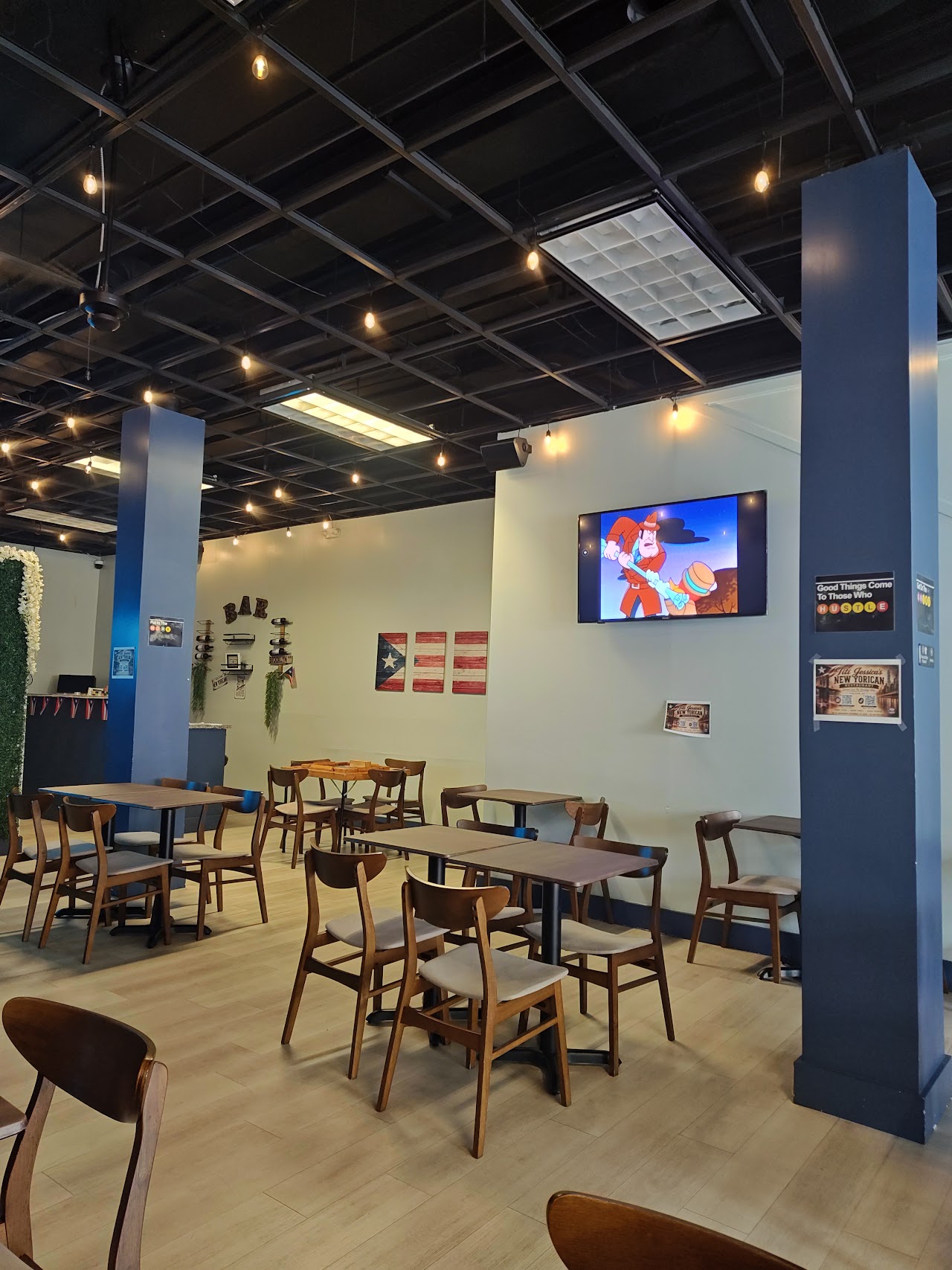 Restaurant interior with warm wood and Yo Soy New Yorican neon sign